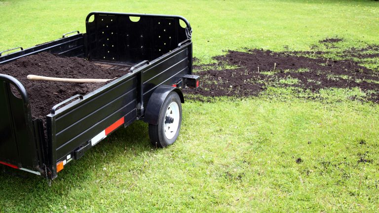 Compost being spread over grass