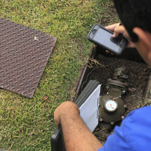 Technician checking water meter