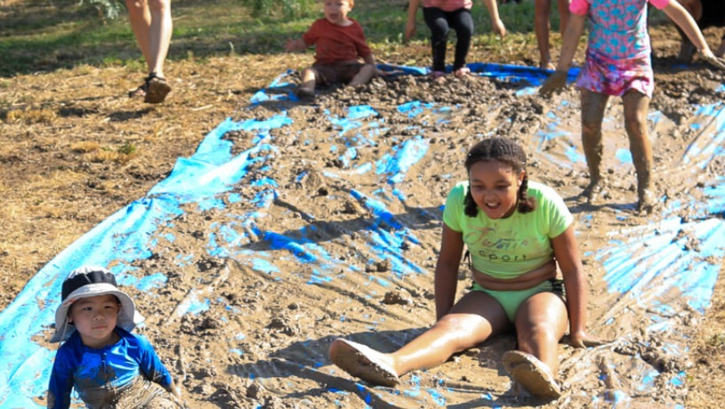 Children sampling a mud slide at San Antonio Botanical Garden