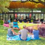 Picnicking visitors enjoying music on the concert lawn at San Antonio Botanical Gardens