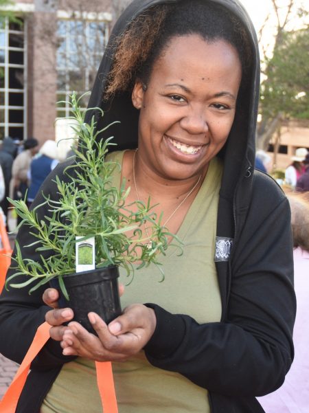 Woman with free plant at SAWS Spring Bloom event.